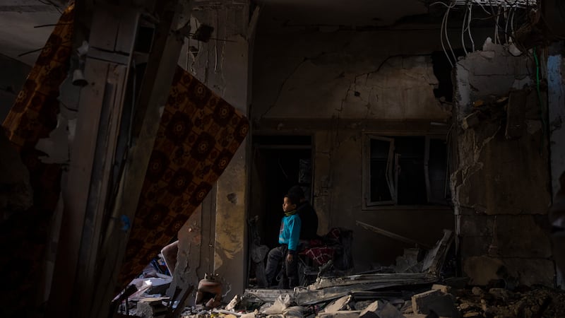 A Palestinian child looks at the damage to his family’s house after an Israeli strike in Rafah, southern Gaza Strip (Fatima Shbair/AP)
