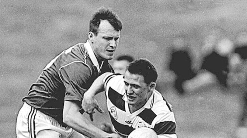 Paul McErlean (right), in action for his club St Paul&#39;s, sensed an improvement in Antrim&#39;s footballing fortunes 20 years ago. 