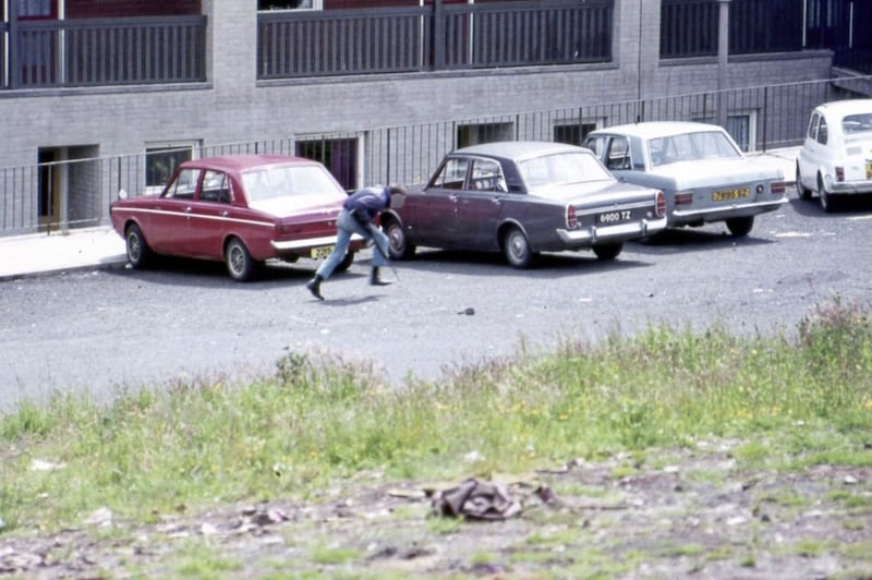 IRA gunman runs for cover in the Lenadoon Flats area during gun battles with the British Army which lasted for six days in July 1972. 