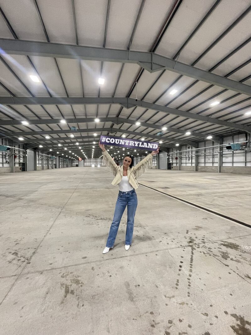 Lisa McHugh stands inside the huge Logan Hall at Balmoral Park which will be transformed into Country Land on November 31 complete with a sprung dance floor