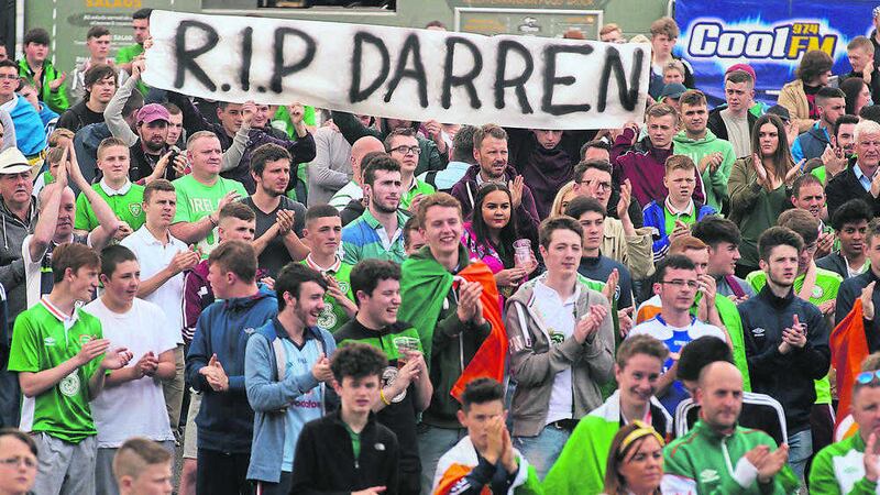 Fans hold a banner in tribute to Darren Rodgers at Titanic slipways in Belfast as the Republic of Ireland&#39;s match against Sweden was shown on the big screen. Picture by Hugh Russell 