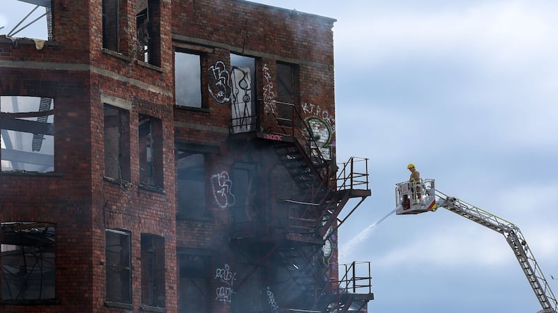 Firefighters at the scene of a fire at a derelict building in Samuel Street in the centre of Belfast. Picture Mal McCann
