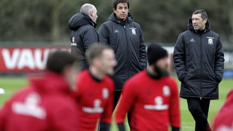 Wales manager Chris Coleman has a chat with his coaching staff during a training session yesterday ahead of tonight&#39;s crucial World Cup qualifier with Republic of Ireland in Dublin Picture: PA 