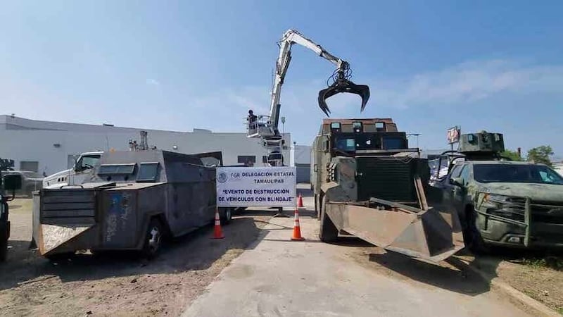 In this undated photo released by the Mexican Federal Attorney General’s Office, a crane hovers over an armored vehicle in Reynosa, Tamaulipas state, Mexico. Authorities in northern Mexico said Sunday, June 18, 2023 that they have destroyed 14 homemade armored cars of the kind used by drug cartels to fight land battles. (Mexican Federal Attorney General’s Office via AP)
