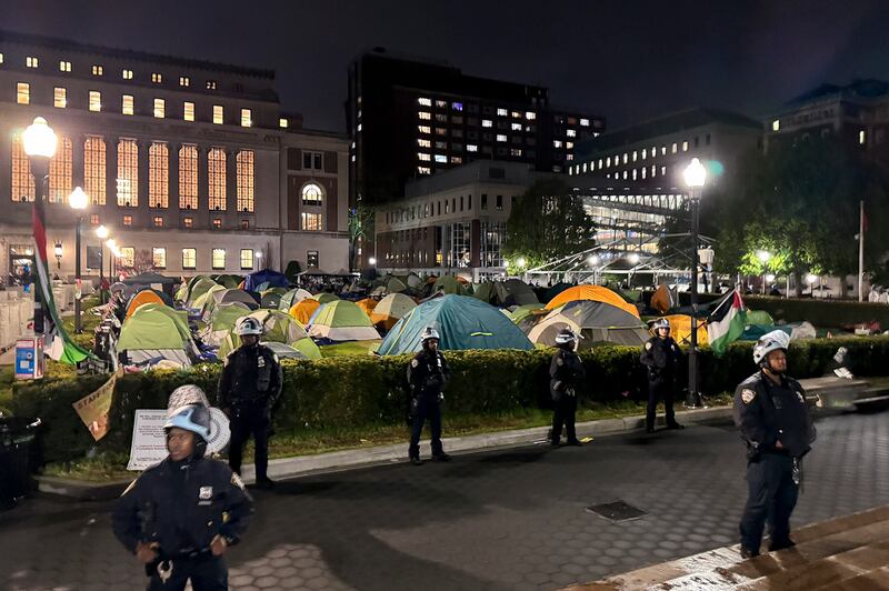 New York Police officers surround the south lawn at Columbia University as protesters are cleared from Hamilton Hall and the encampment (NYPD/AP)