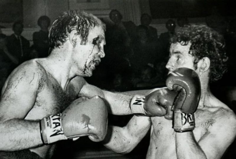Battered and bloodied, Davy Larmour and Hugh Russell fight to the last at the Ulster Hall in October 1982. Picture by Brendan Murphy