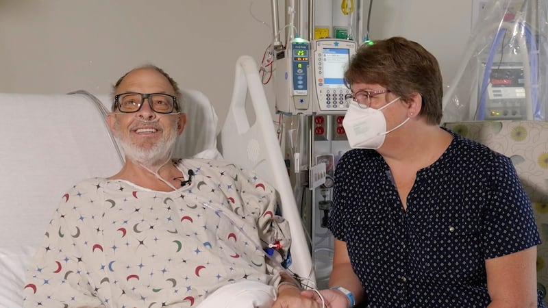 Lawrence Faucette sits with his wife, Ann, in hospital (Mark Teske/University of Maryland School of Medicine via AP)