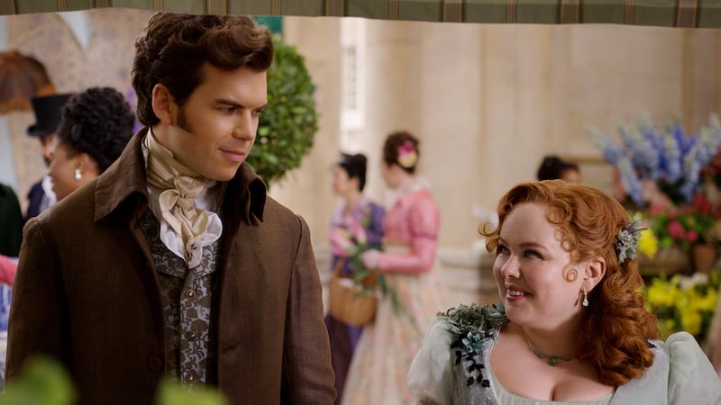 A scene from Bridgerton in which Penelope gazes adoringly at Colin