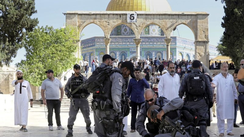 Israeli police officers arrest a Palestinian during clashes with Palestinians by the Dome of the Rock Mosque in the Al Aqsa Mosque compound in Jerusalem&#39;s old city Picture by Mahmoud Illean/AP 