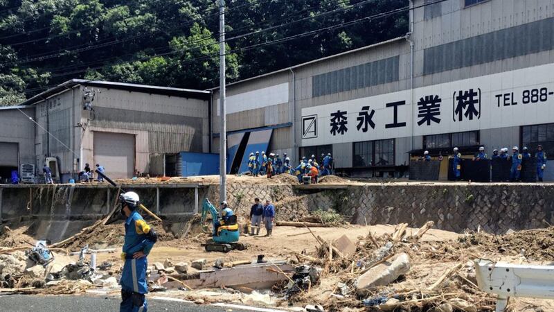 Rescuers remove the debris to clear an area hit by a mudslide caused by heavy rains in Hiroshima, southwestern Japan Picture by Haruka Nuga/AP 