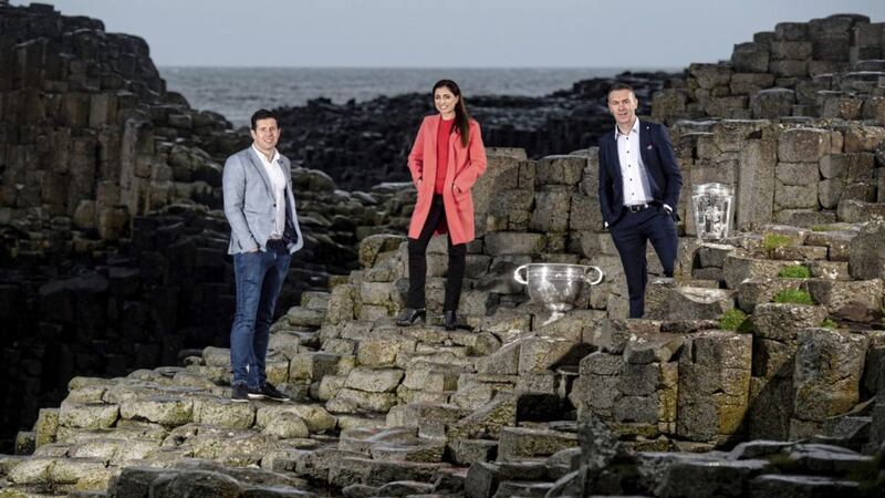 Se&aacute;n Cavanagh, Joanne Cantwell and Oisin McConville with the Sam Maguire and Liam MacCarthy cups at the Giants Causeway as they launch RT&Eacute;'s Championship coverage. Picture by Sportsfile