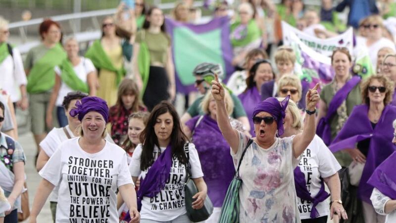 People march through Belfast dressed in the colours of the suffragette movement to celebrate 100 years since women were granted the vote. Picture by Niall Carson/PA Wire 