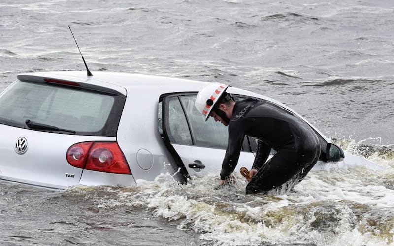 In poor weather conditions with high winds and waters rough, the car had already taken in a substantial amount of water and was at risk of drifting further from the shore when PSNI officers arrived.Picture by Justin Kernoghan.
