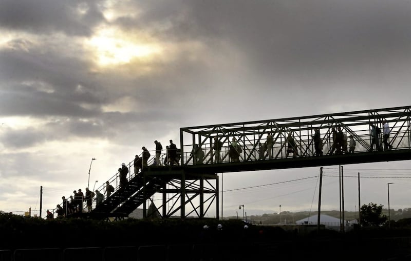 As the sun breaks through, crowds make their way across the foot bridges for The Open at Royal Portrush on Thursday. Picture by Margaret McLaughlin&nbsp;