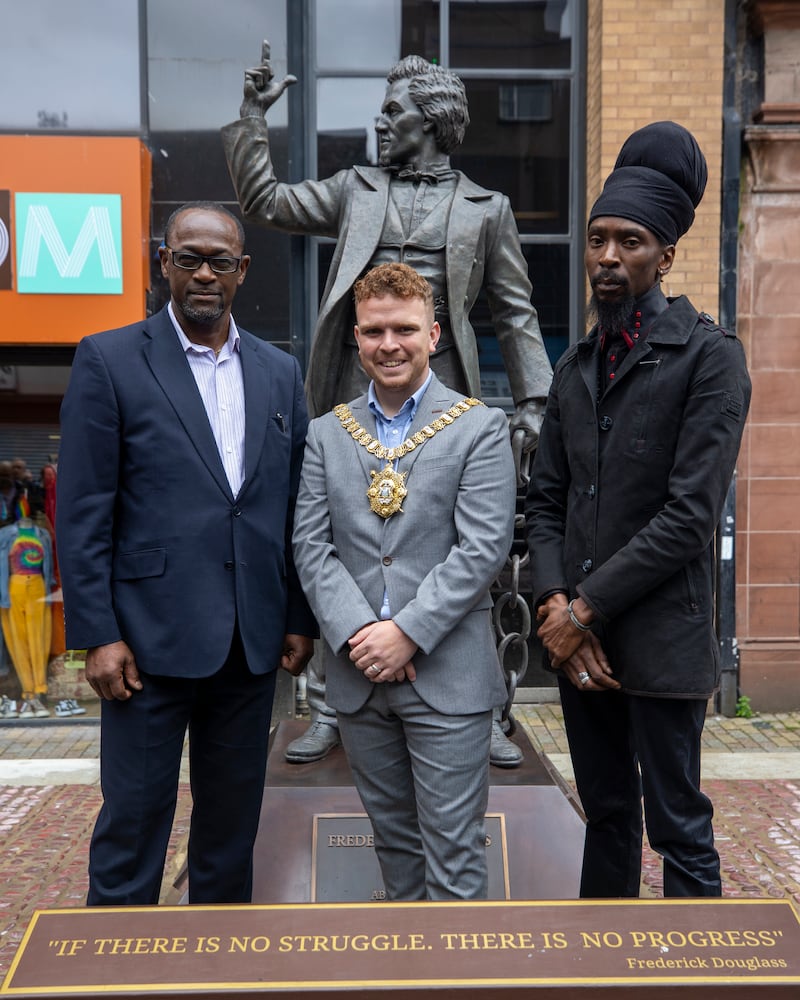 Councillor Ryan Murphy, centre, with Livingstone Thompson, left, and Tukura Makoni, from the African and Caribbean Support Organisation Northern Ireland