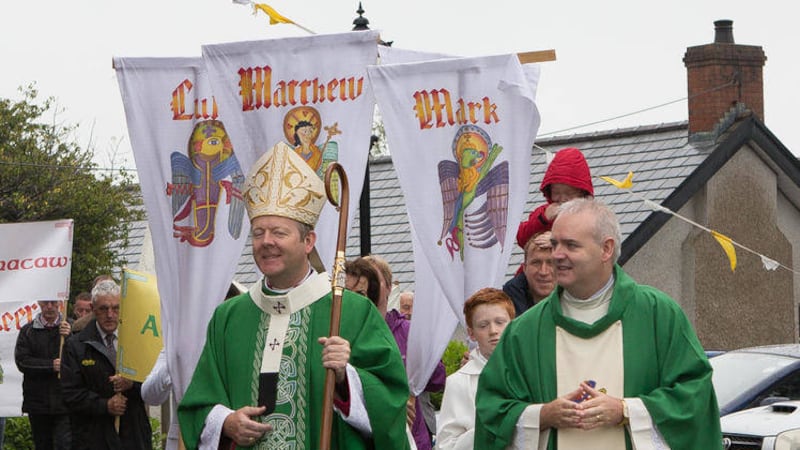 Archbishop Eamon Martin and Fr David Moore lead a procession of townland banners to the Church of the Assumption in Pomeroy 