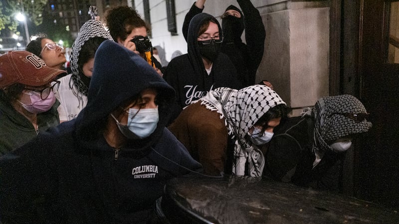 Students with the Gaza Solidarity Encampment block the entrance of Hamilton Hall at Columbia University (Marco Postigo Storel via AP)