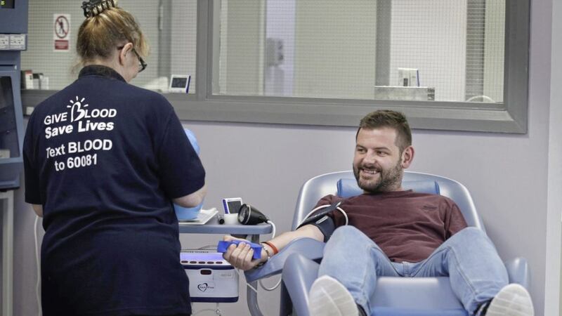 Stevie Maginn make history with what is thought to be the first blood donation since the relaxation of Northern Ireland&#39;s controversial gay blood restrictions in April. Picture by Hugh Russell. 
