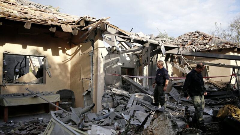 Police officers inspect the damage to a house hit by a rocket in Mishmeret, central Israel. Picture by Ariel Schalit/AP 