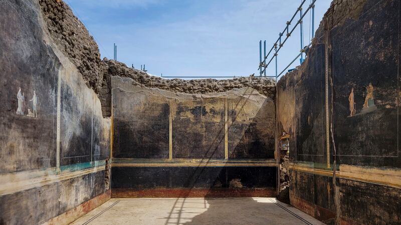 A banquet hall, with elegant black walls, decorated with mythological subjects inspired by the Trojan War, recently unearthed in the Pompeii archaeological area near Naples in southern Italy (Italian Culture Ministry/AP)