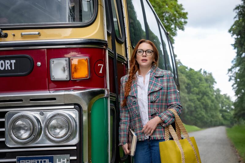 Lindsay Lohan as Maddie Kelly in the movie Irish Wish, standing beside a bus