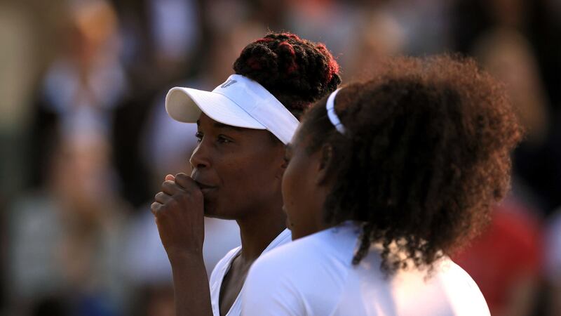 Venus Williams (left) and sister Serena during their doubles match on day eight of Wimbledon on Tuesday. Picture by Press Association