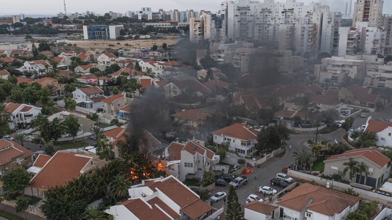 Smoke rises after a rocket fired from the Gaza Strip hit a house in Ashkelon, southern Israel (Tsafrir Abayov/AP)
