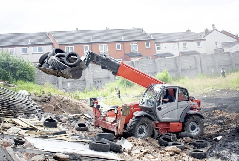 Tyres being removed last year from a bonfire site at Lismore Street in south-east Belfast 