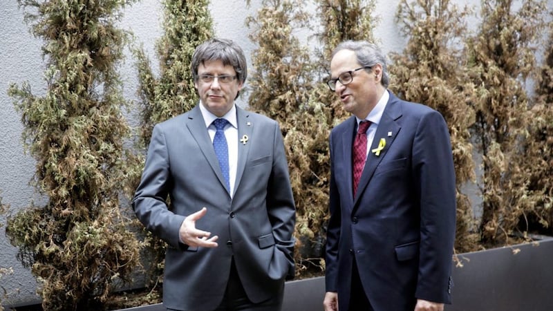 Former Catalan leader Carles Puigdemont, left, talks to Catalan president Quim Torra, right, prior to a news conference in Berlin, Germany on Tuesday. Picture by Markus Schreiber, Associated Press 