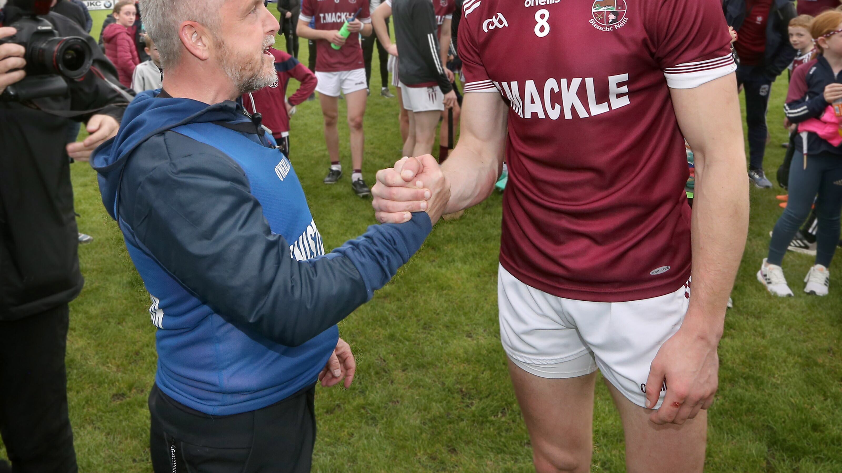 Slaughtneil manager Michael McShane and hat-trick hero Brendan Rogers shake hands after earning the club's 11th consecutive Derry hurling title. Picture by Margaret McLaughlin