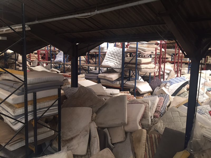 Discarded mattresses at a recycling centre.