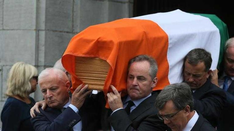 The coffin of Peter Barry is carried from St Michael's Church, Blackrock, Cork. Picture by Brian Lawless, Press Association