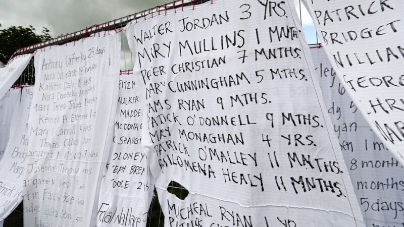 Bed sheets with the names of hundreds of dead children draped on the gates of a mass burial site at Tuam, Co Galway 