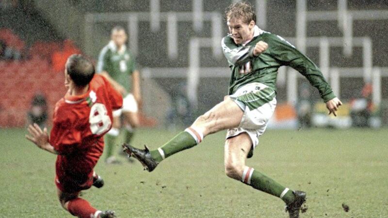Steve Staunton (Republic of Ireland) blasts the ball past John Robinson (Wales) during a friendly match in Cardiff on Tuesday February 11 1997. Picture by David Jones/PA. 