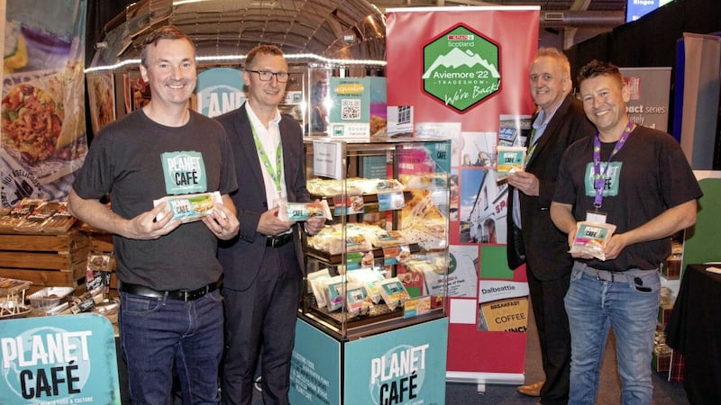 Stewart Ferguson and Stephen Brown (centre) from CJ Lang, with Ronan Gourley (left) and Philip Woods (right) of Planet Caf&eacute;, after the Scottish Spar wholesaler signed a new supply deal with the Warrenpoint-based food firm. 
