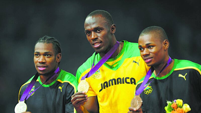 Jamaica's (left-right) Yohan Blake Silver Usain Bolt Gold and Bronze medalist Warren Weir celebrate at the Olympic Stadium London.