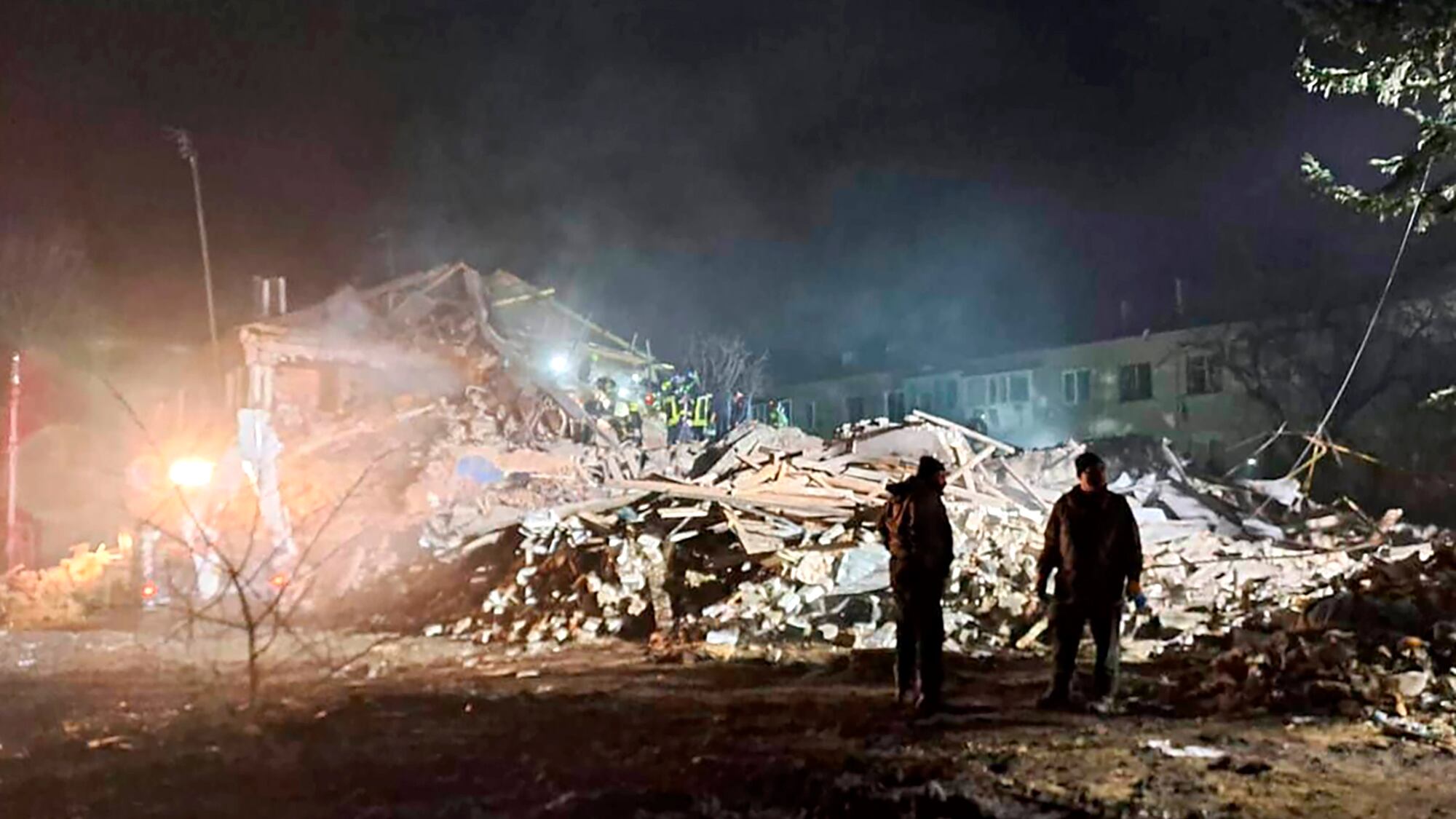 Firefighters examine the site of a Russian missile attack that hit an apartment building in Kharkiv (Kharkiv Regional Governor Oleh Sunyiehubov Office/ via AP)