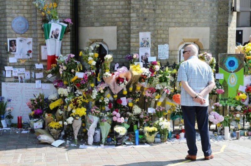 People lay flowers outside Notting Hill Methodist Church