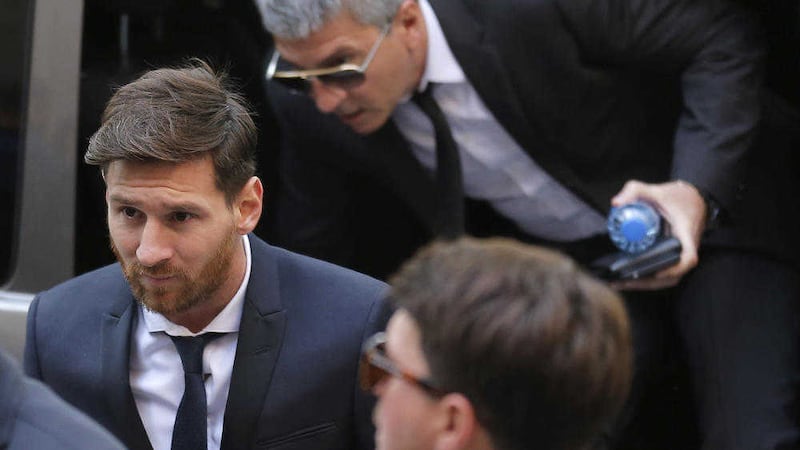 Barcelona soccer player Lionel Messi, left, arrives at a court in Barcelona, Spain. Messi and his father, Jorge Horacio, have been charged with three counts of tax fraud. Picture by Manu Fernandez/AP 