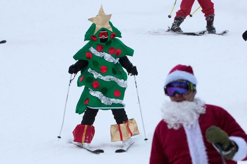 A skier dressed as a Christmas tree skis for charity at the Sunday River Ski Resort in Newry, Maine