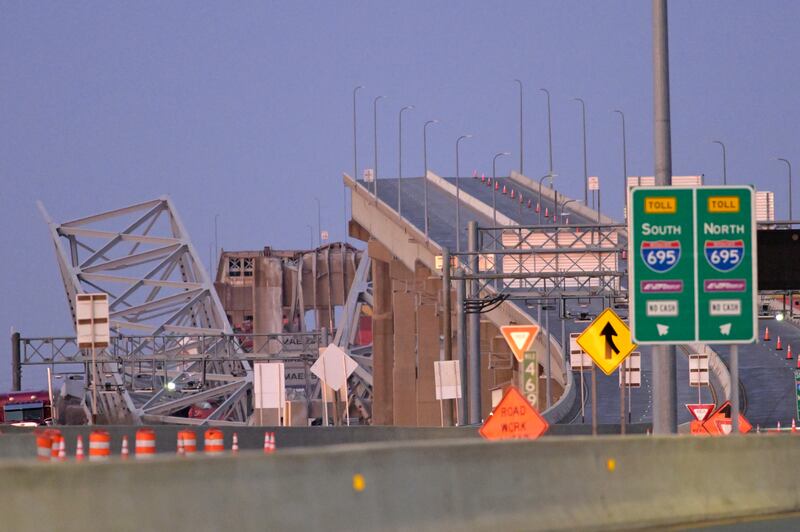 The jagged remnants of the bridge’s steel frame were visible protruding from the water (AP Photo/Steve Ruark)