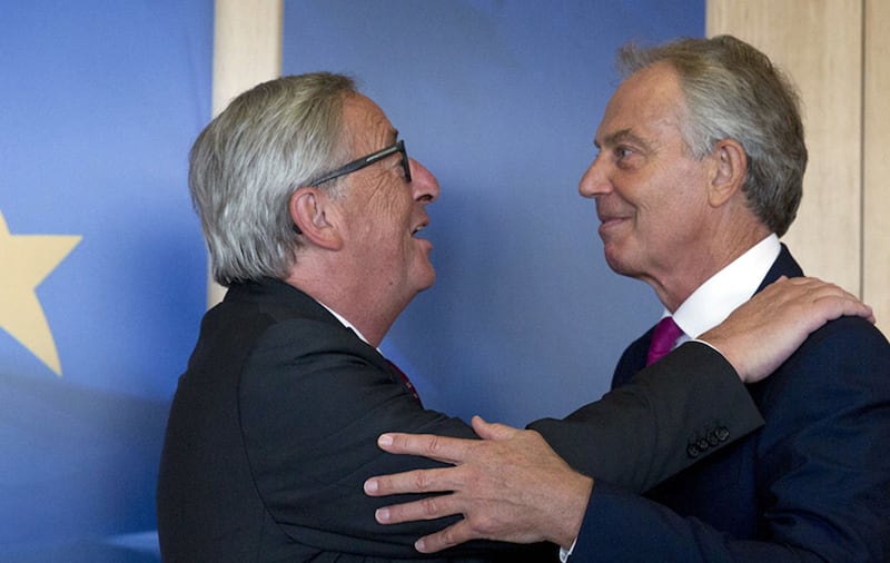 European Commission President Jean-Claude Juncker, left, warmly welcomes former British Prime Minister Tony Blair prior to a meeting at EU headquarters in Brussels on Thursday, Aug. 31, 2017. (AP Photo/Virginia Mayo)