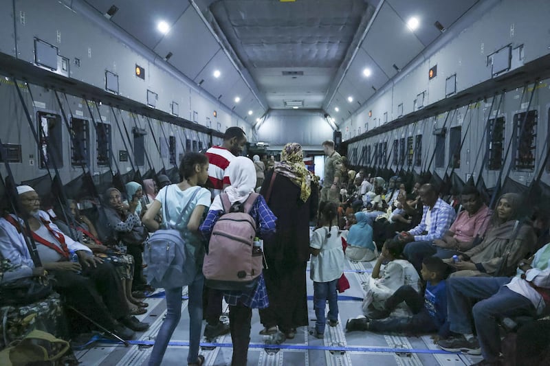 A family board an RAF plane bound for Cyprus during the evacuation from Wadi Seidna Air Base in Sudan in May 2023