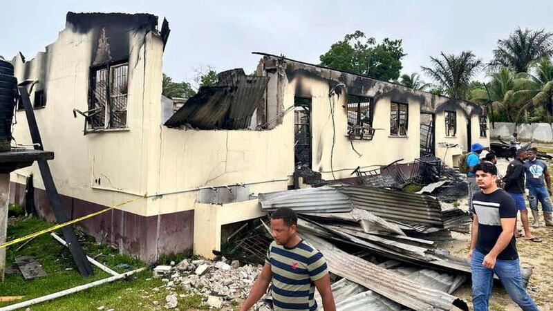 A fire raced through the dormitory on Monday (Guyana’s Department of Public Information/AP)