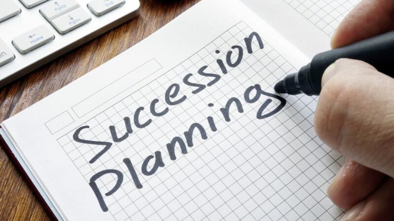 Man is writing succession planning in the book.. 