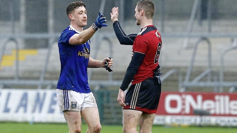 Cavan's Oisin Pierson with Down captain Caolan Mooney after the Ulster SFC semi-final.<br /> Pic Philip Walsh