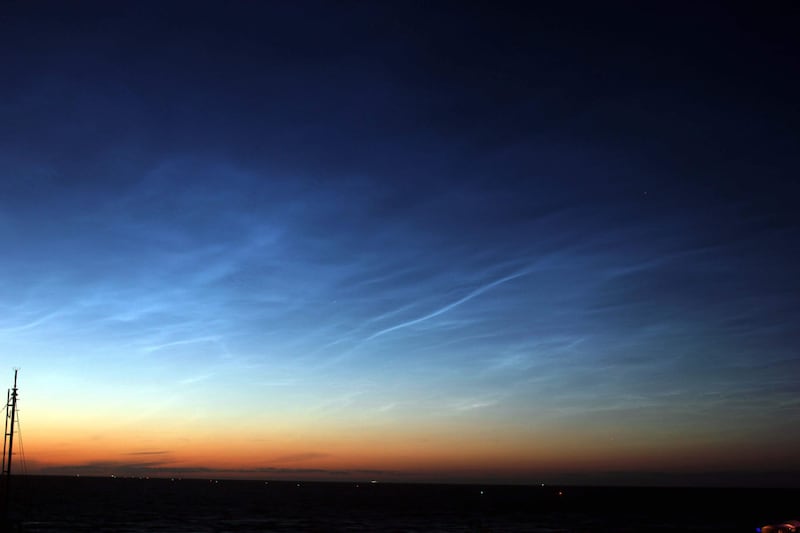 Noctilucent clouds at night sky.