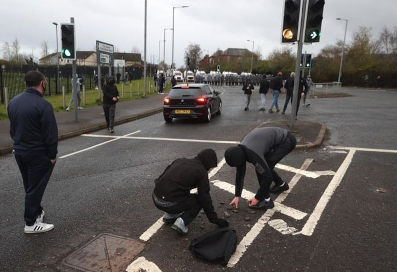 &nbsp;Youths pick up stones to throw at PSNI officers on the Springfield road, during further unrest in Belfast. Picture date: Thursday April 8, 2021.