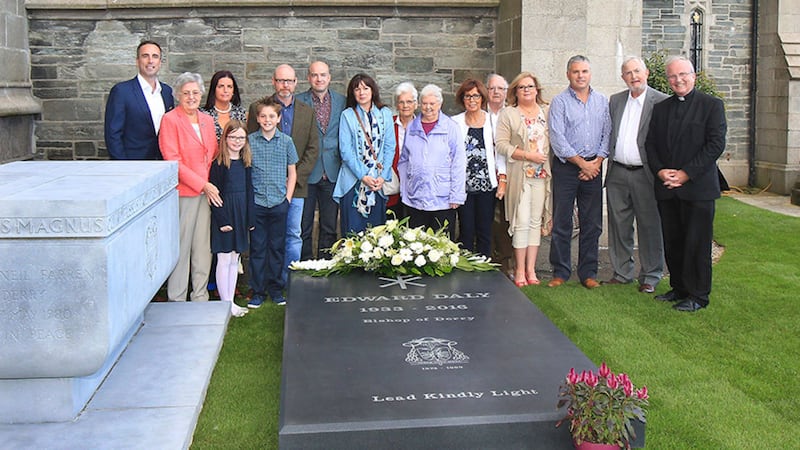 The family of the late Bishop Edward Daly together with Bishop Donal McKeown gather at the new stone placed over his grave in the grounds of St Eugene's Cathedral in Derry&nbsp;