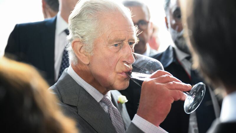 Charles drinking a glass of red wine during his trip to Bordeaux (Daniel Leal/PA)